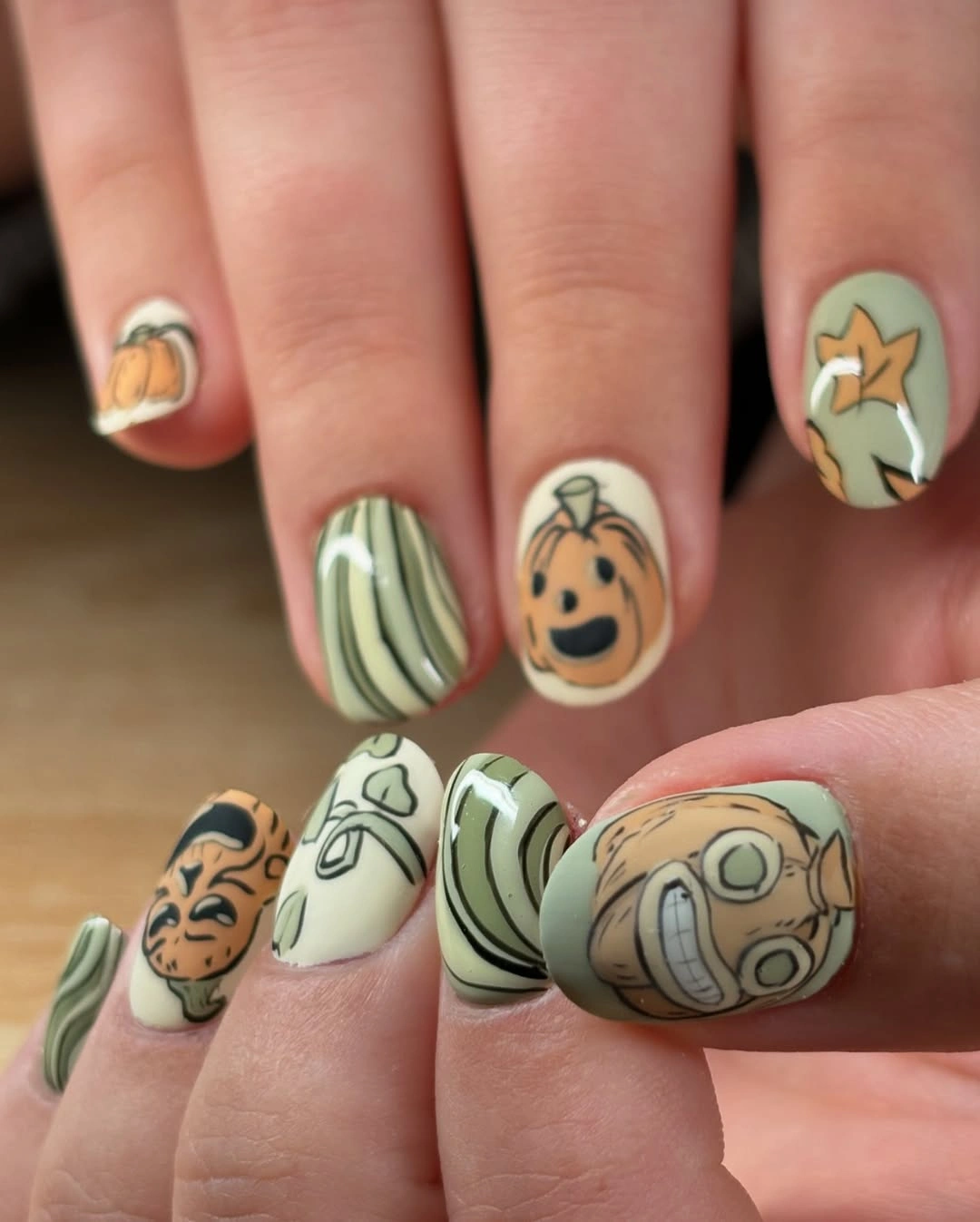 Short sage nails with cream pumpkin and seasonal drawings