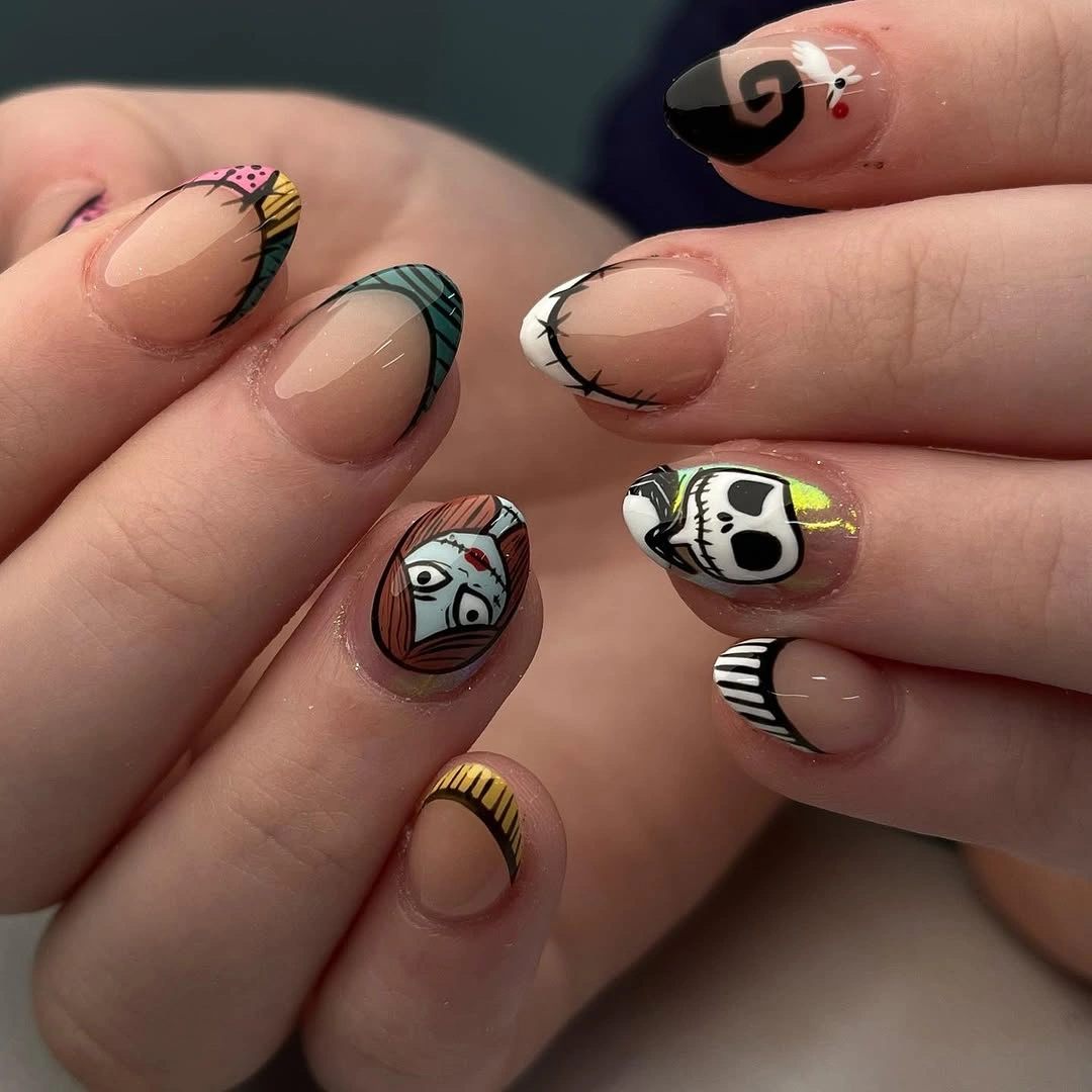 Short nude nails with tiny black white Halloween icons