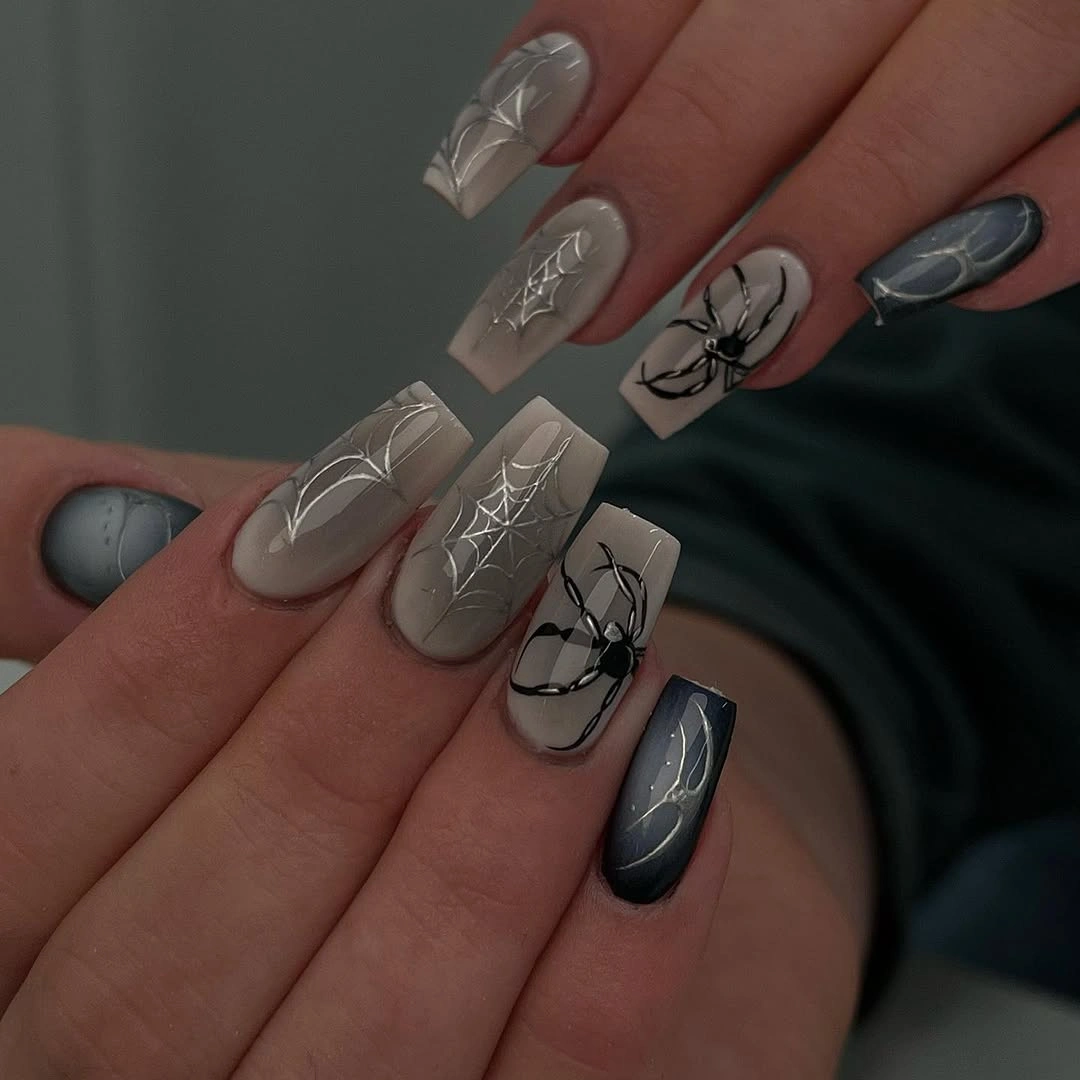 Long smoky gray nails with silver webs and blue accents