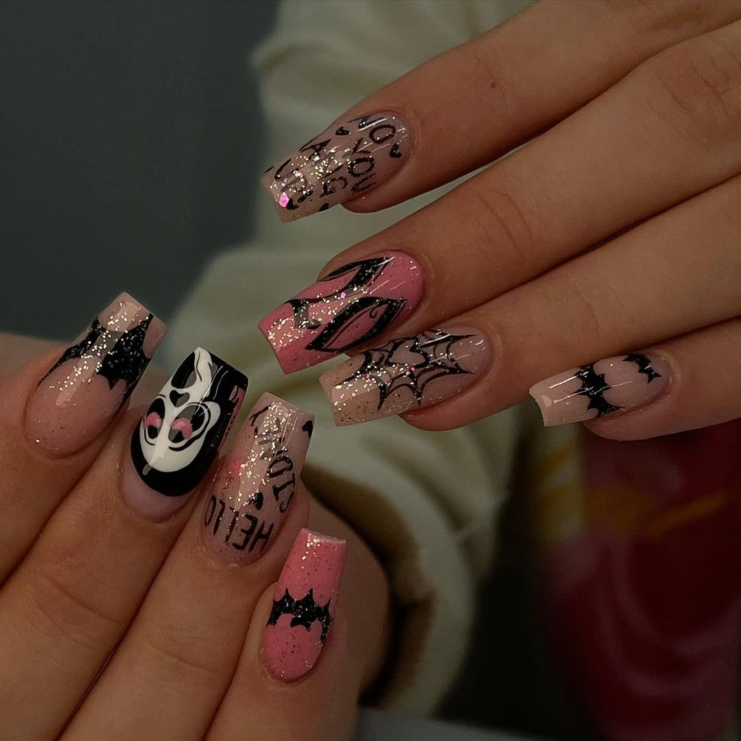 Long pink nails with webs faces glitter and black details