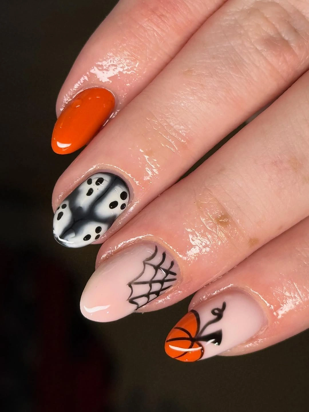 Short nude square nails with pumpkin, ghost, spiderweb, and black spotted accent