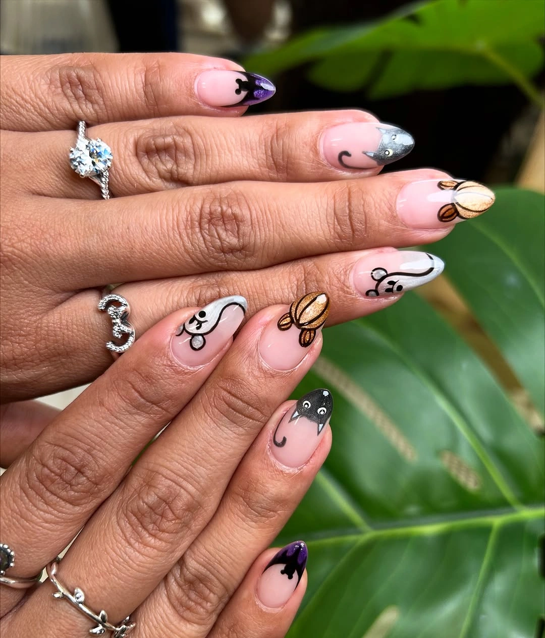 Long almond nails with pink orange purple character details