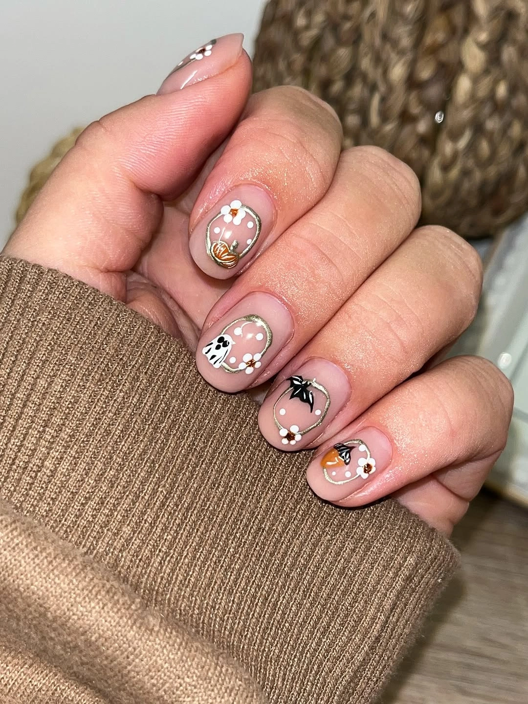 Sheer taupe nails with tiny flowers and reflective accents