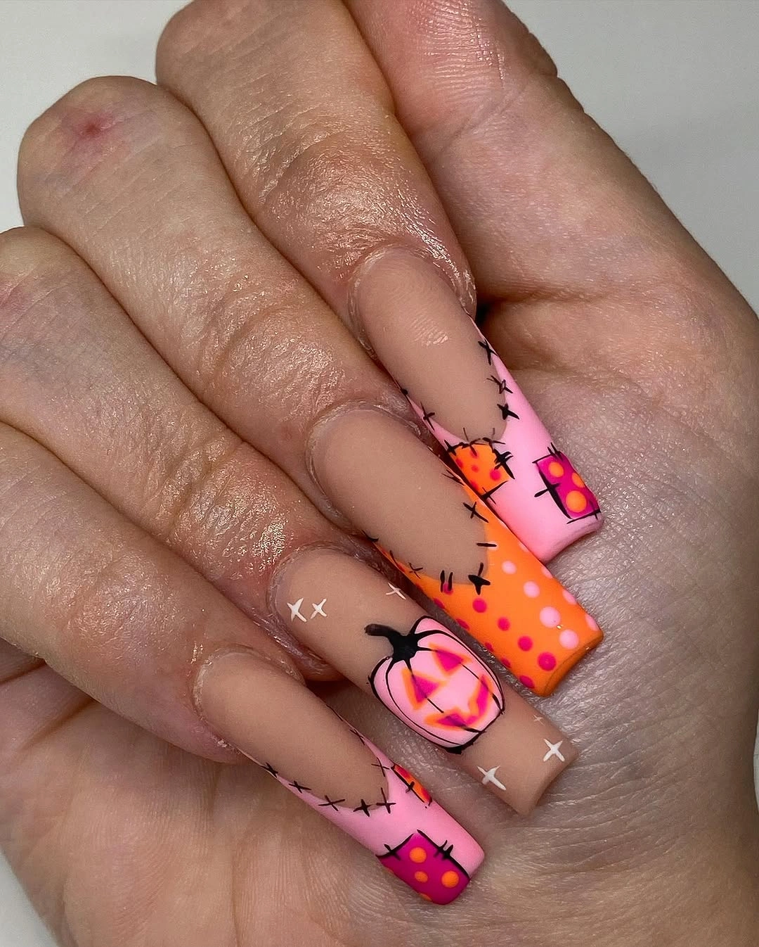 Long coffin nails with neon pink orange stitched blocks