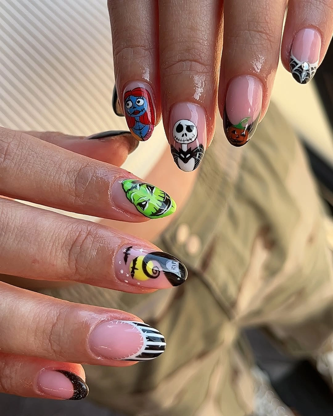Pink almond nails with colorful Halloween characters and stripes