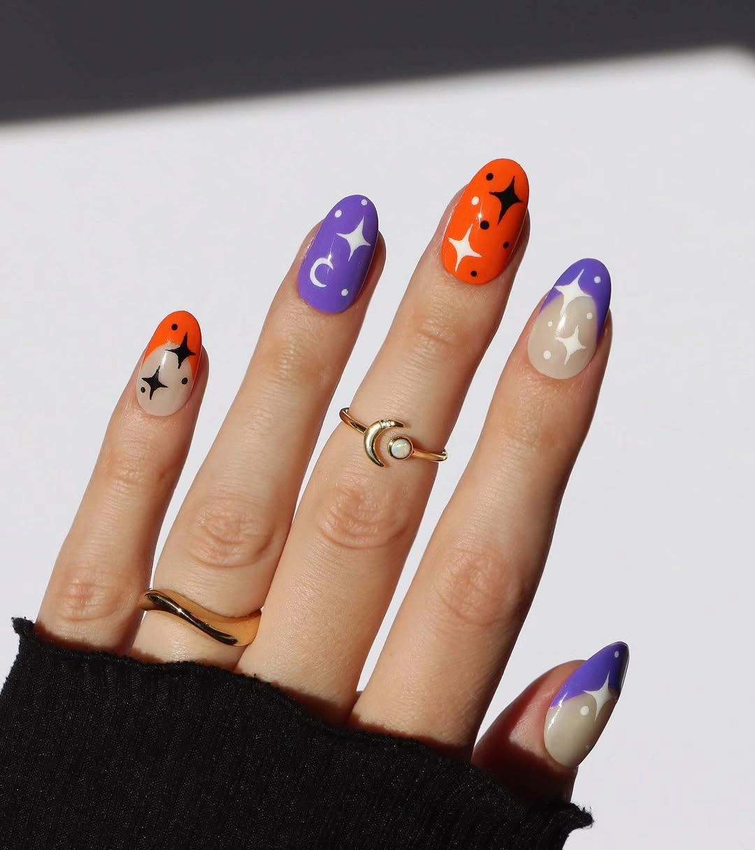 Purple and orange almond nails with white moons and ghosts