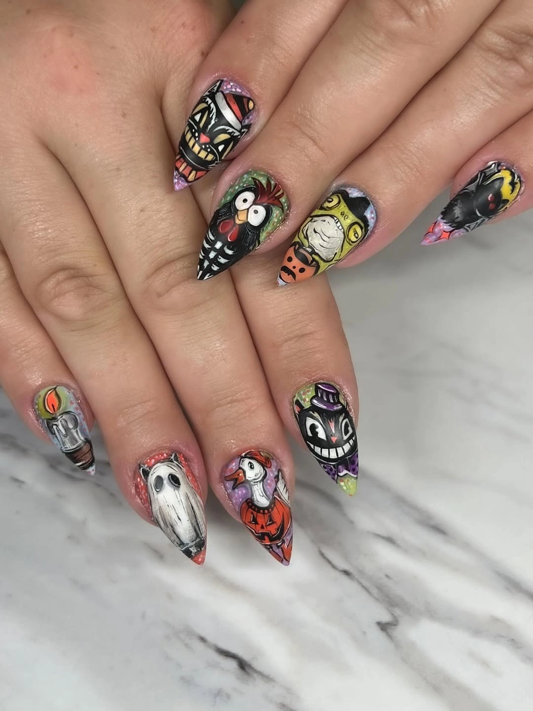 Long pointed nails with dark Halloween faces and layered art