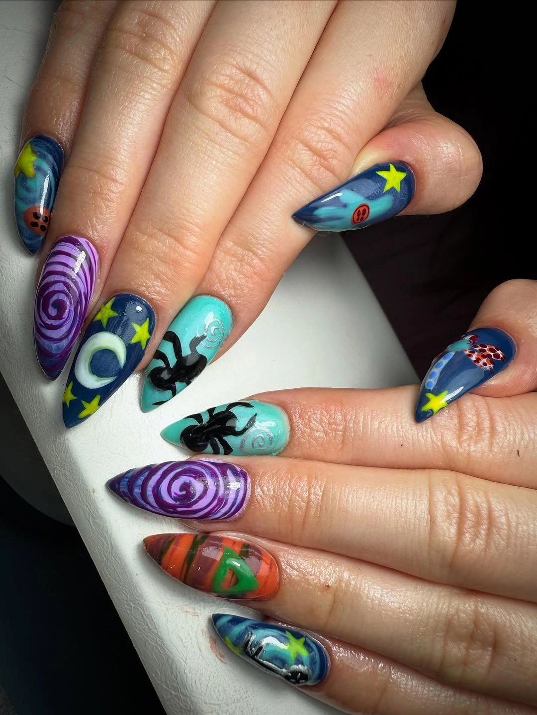 Long coffin nails with teal purple cosmic Halloween details
