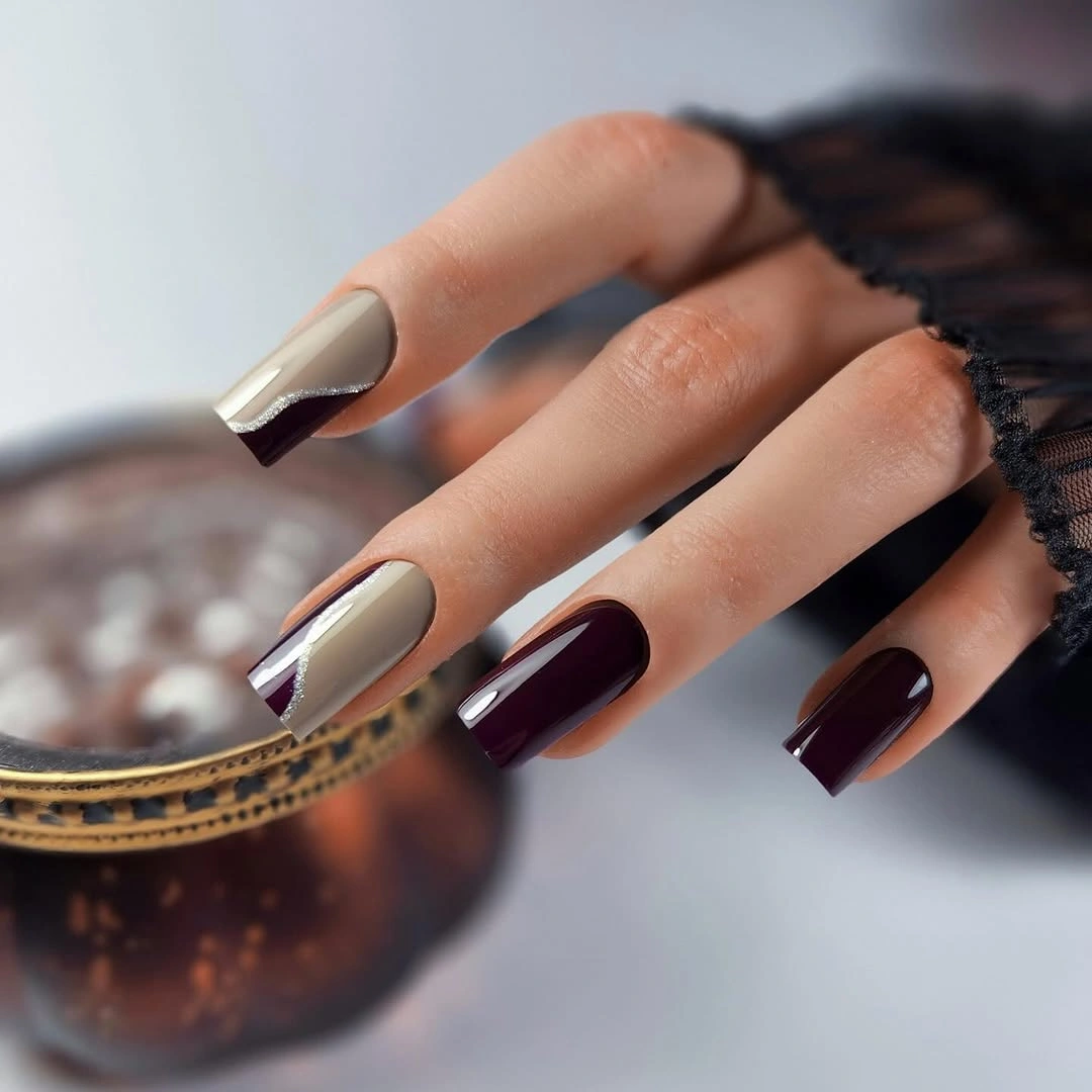 Medium square nails with warm beige panels and deep burgundy color blocks