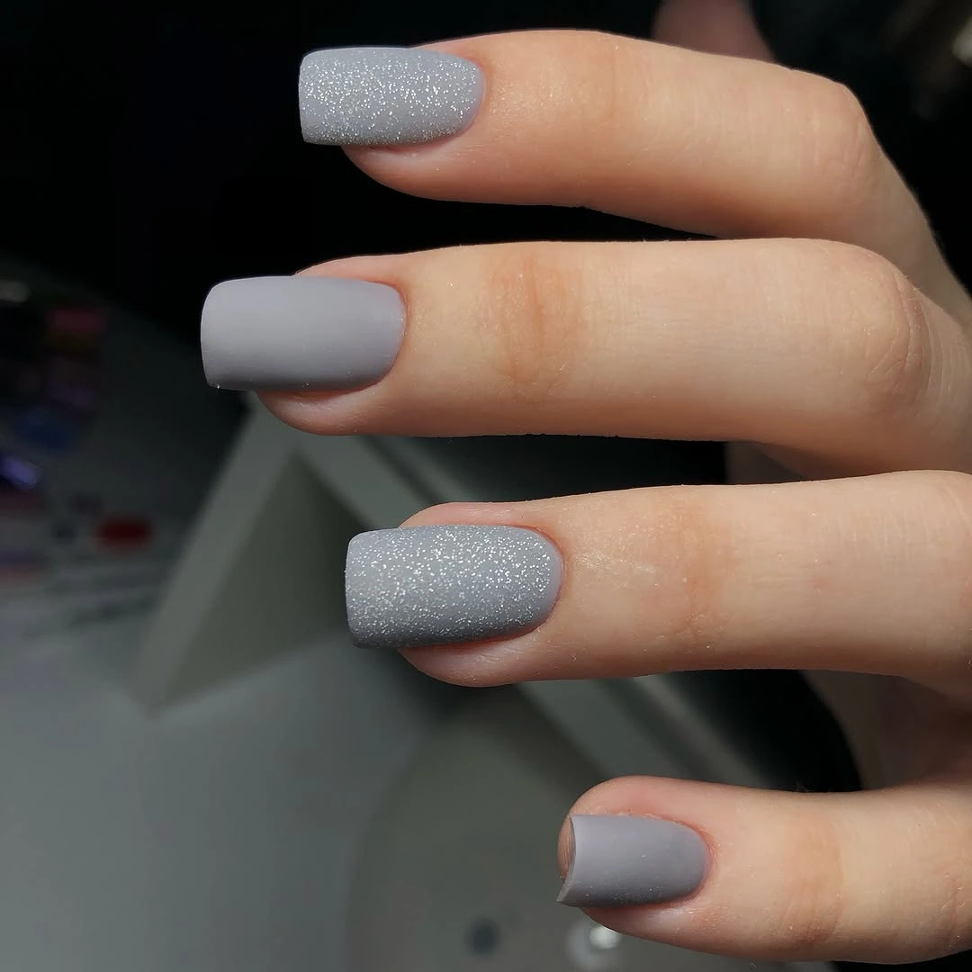 Short gray matte square nails with alternating dense silver glitter accents