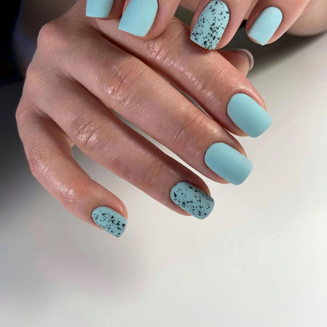 Powder blue matte square nails with black speckled accent nails