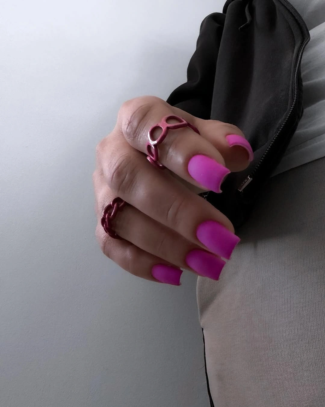 Long square nails in vivid fuchsia pink with an even matte finish