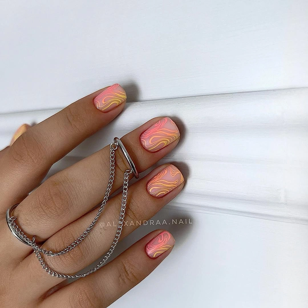 Short coral pink nails with thin yellow wavy contour lines