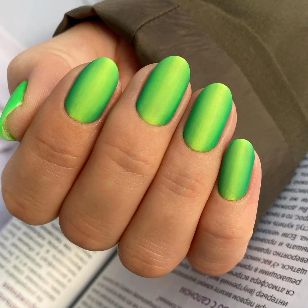 Short oval nails in vivid neon lime with a matte finish