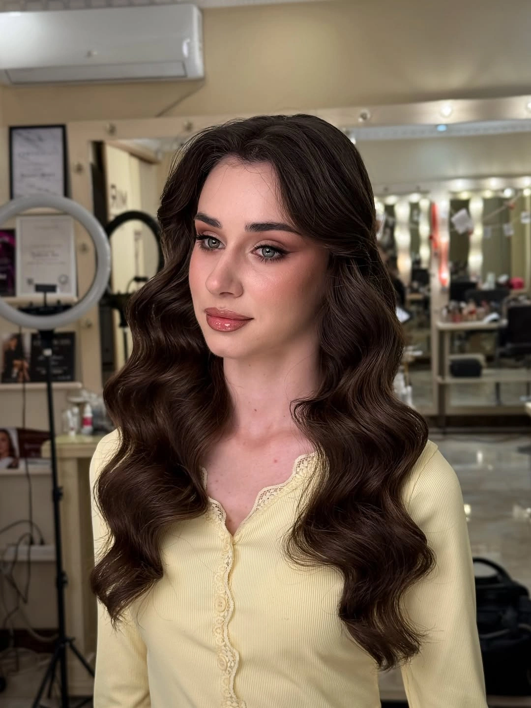 dark center part surrounded by full defined brown curls