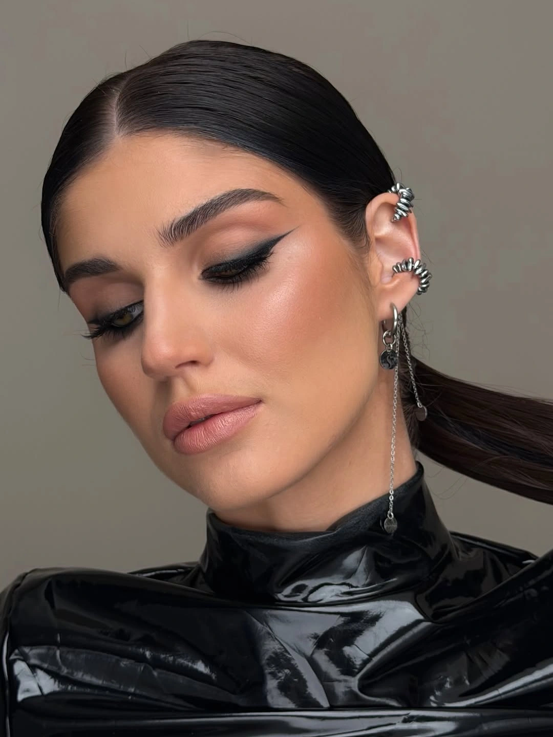 smooth middle part low ponytail with ear cuff detail