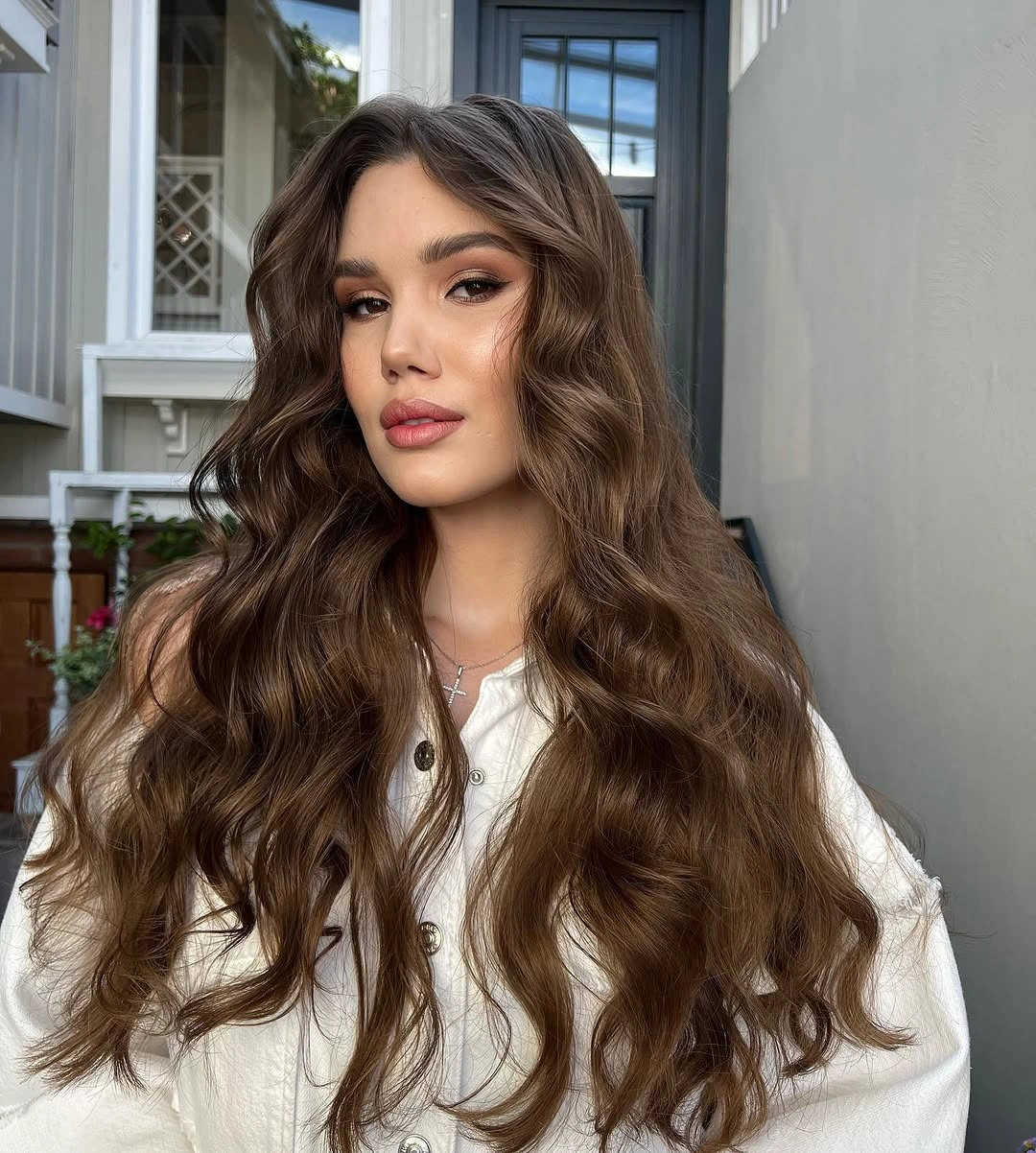 very long brown middle part with loose curls over shoulders