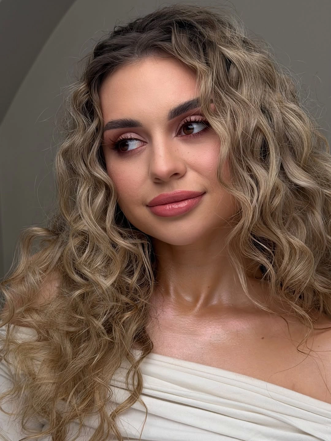 soft tousled blonde brown curls around a middle part