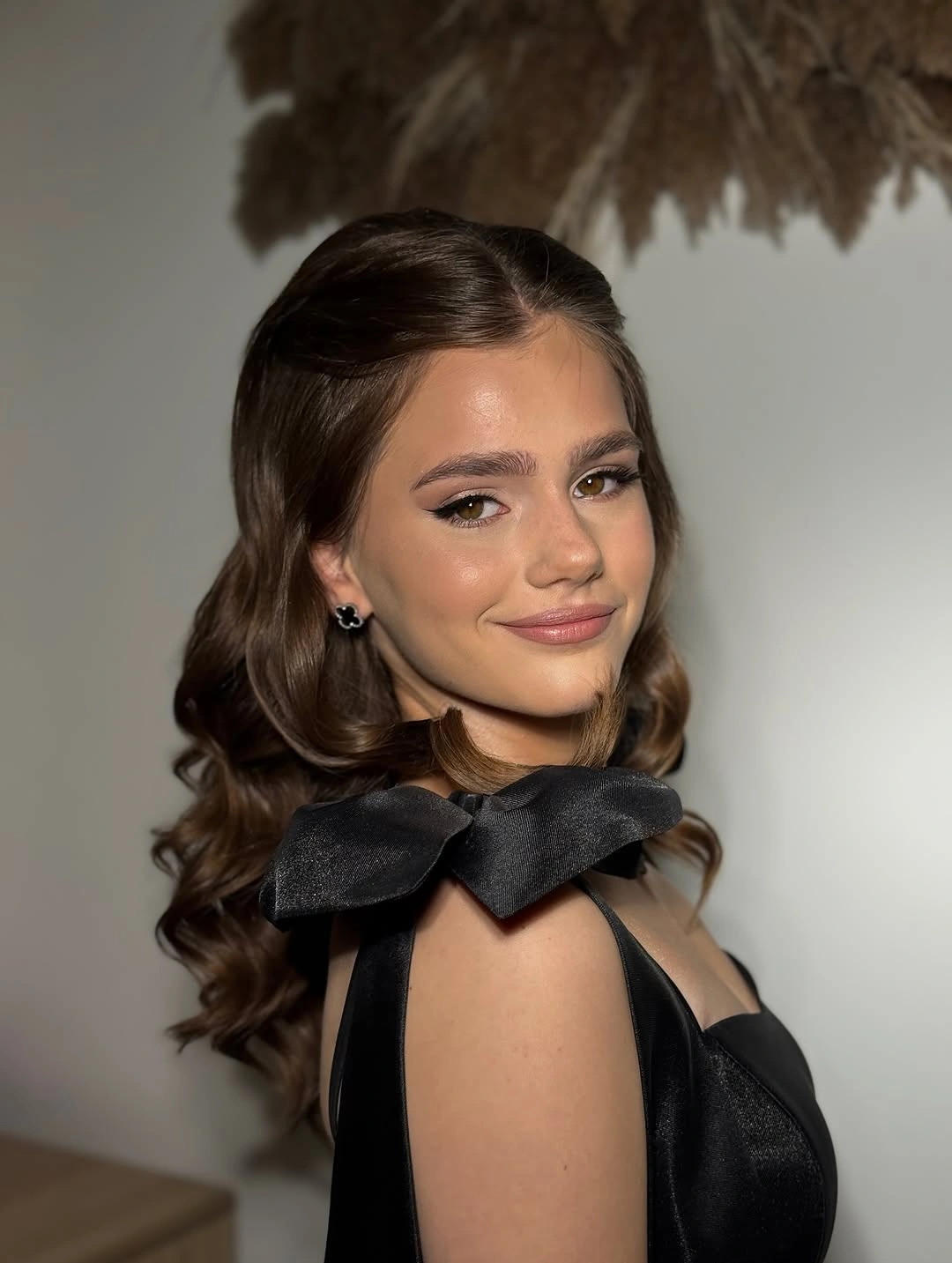 middle part half up waves with oversized black bow