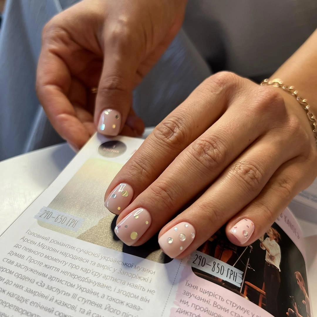 Short nude square nails with tiny scattered accents