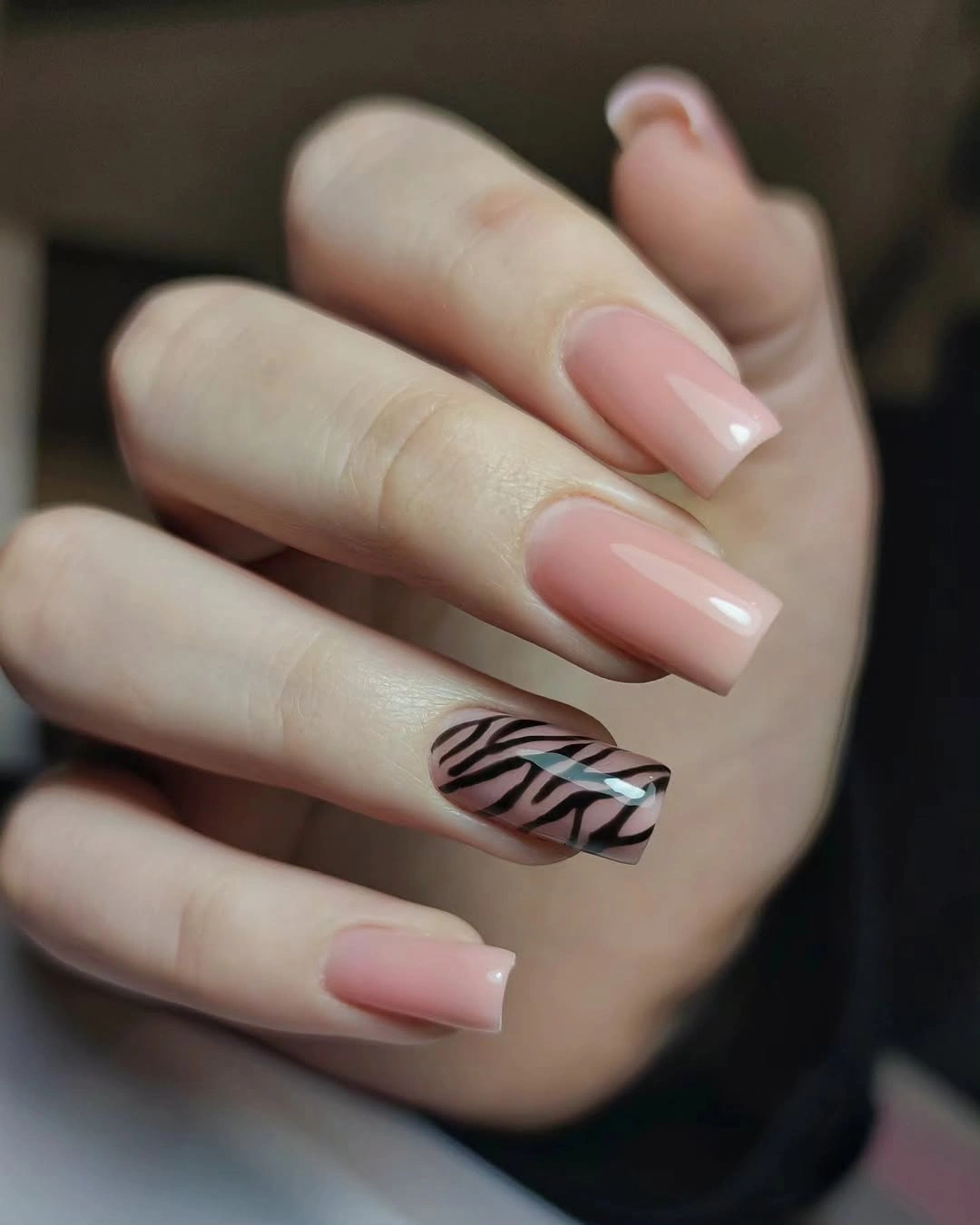 Medium pink square nails with one zebra accent