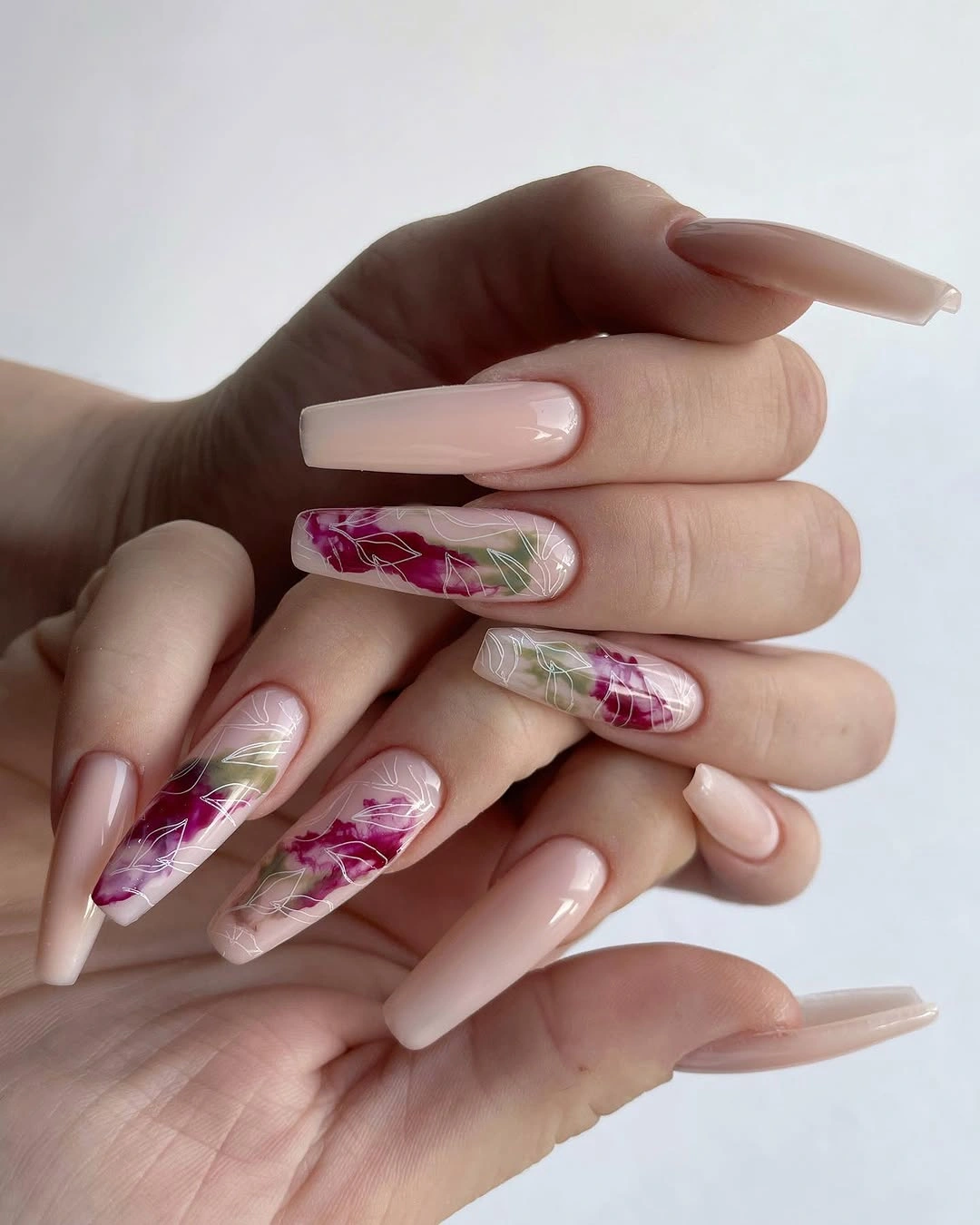 Long pale pink coffin nails with botanical accents