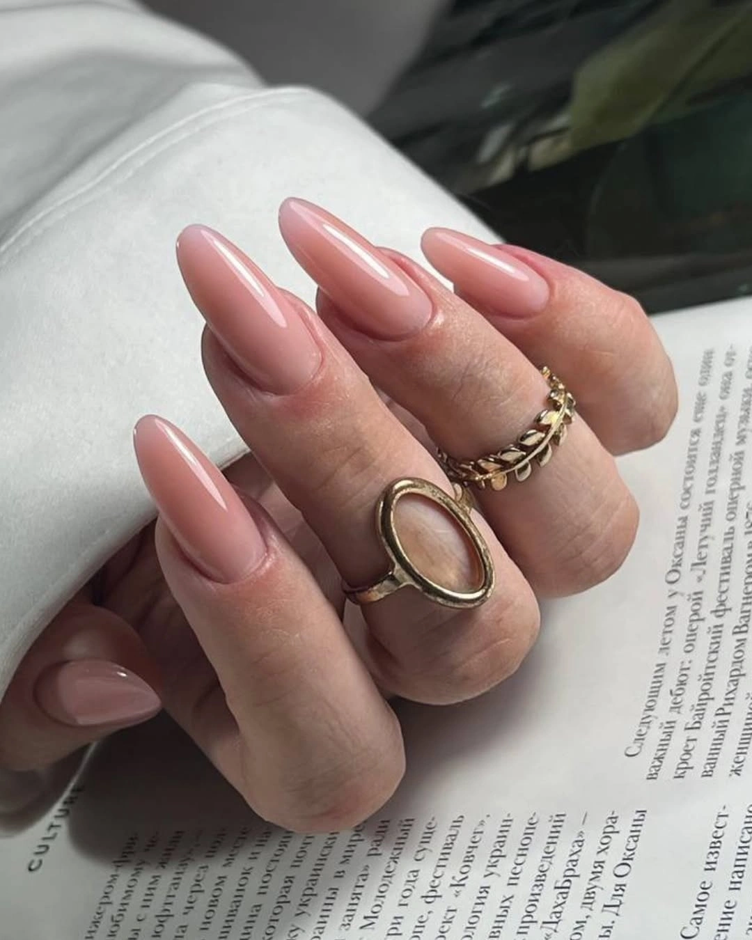 Long pale pink glossy almond nails