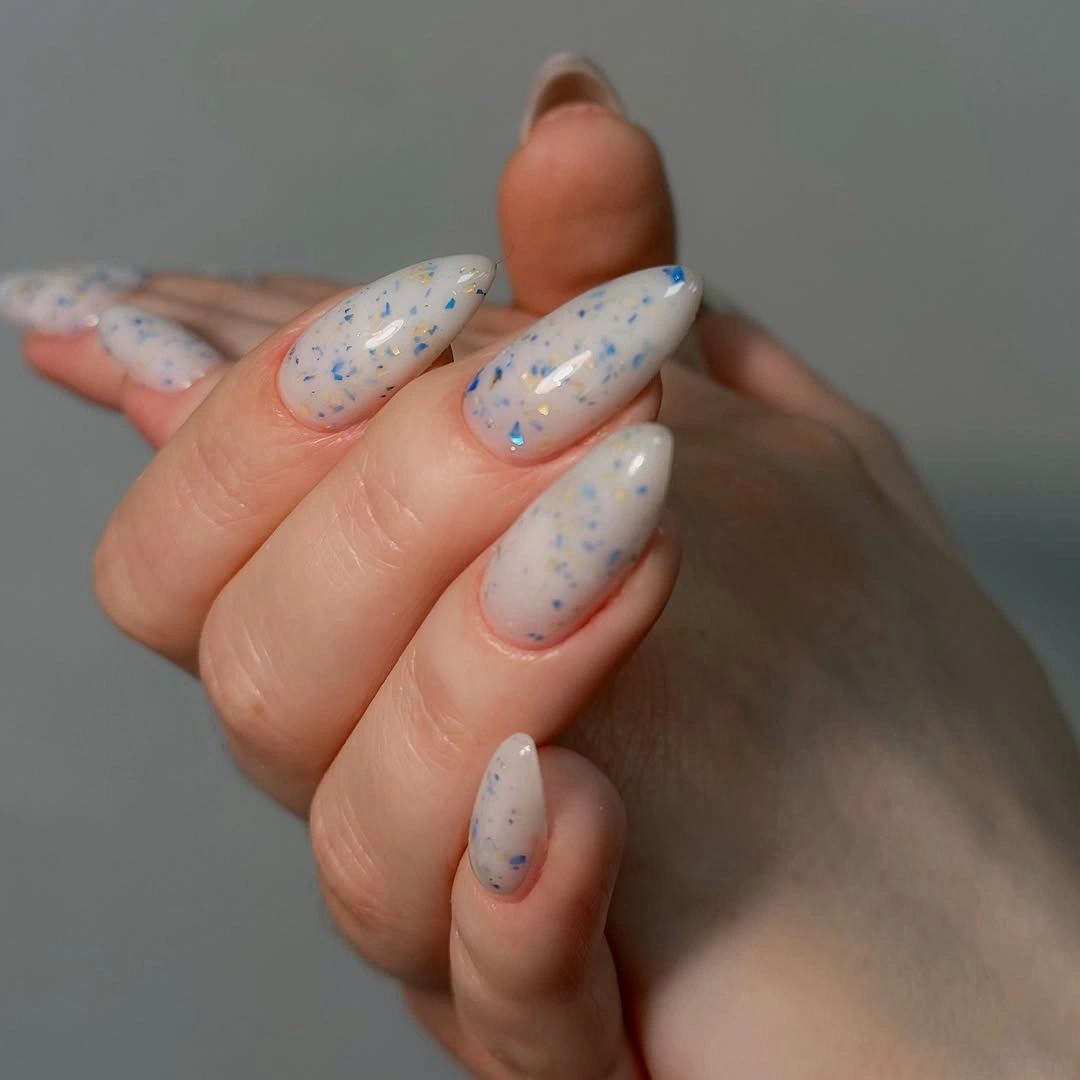 Long pale almond nails with blue specks