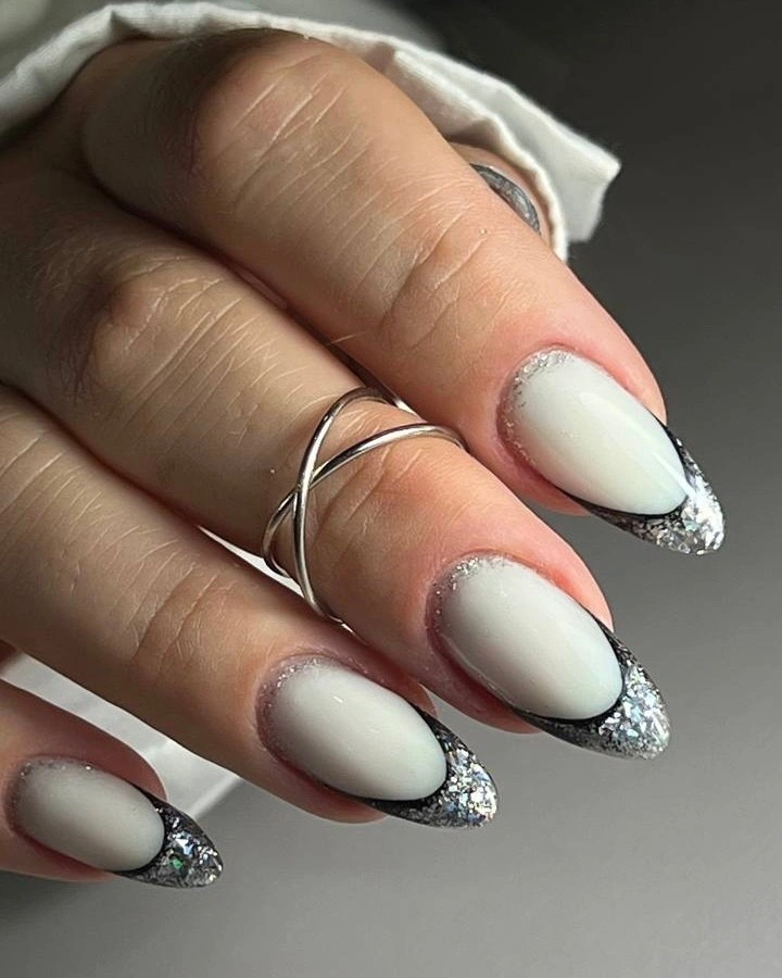 Medium white almond nails with dark glitter tips