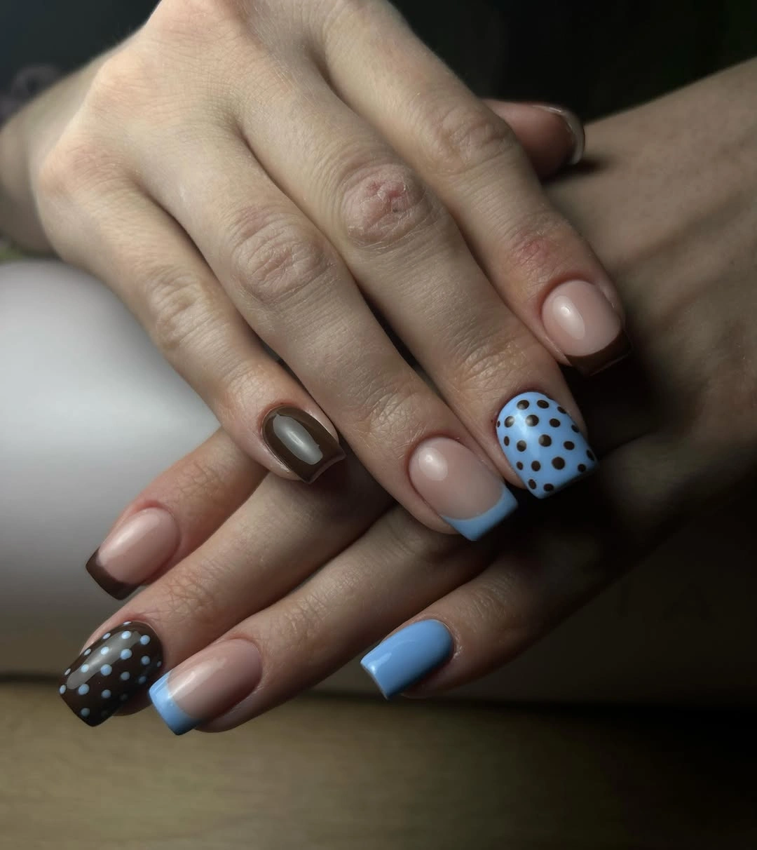 Medium square nude nails with blue and brown dotted French tips