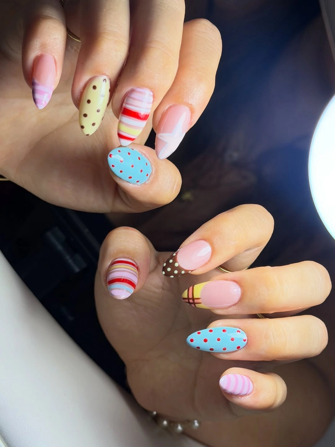 Pastel almond nails with gentle stripes dots and mixed small color sections