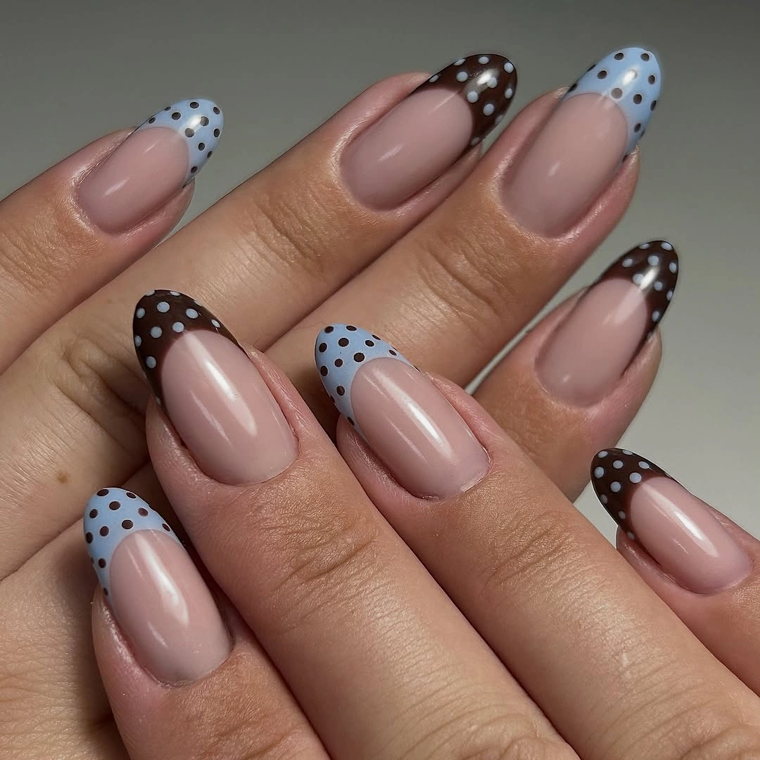 Long nude almond nails with brown and pale blue dotted French tips