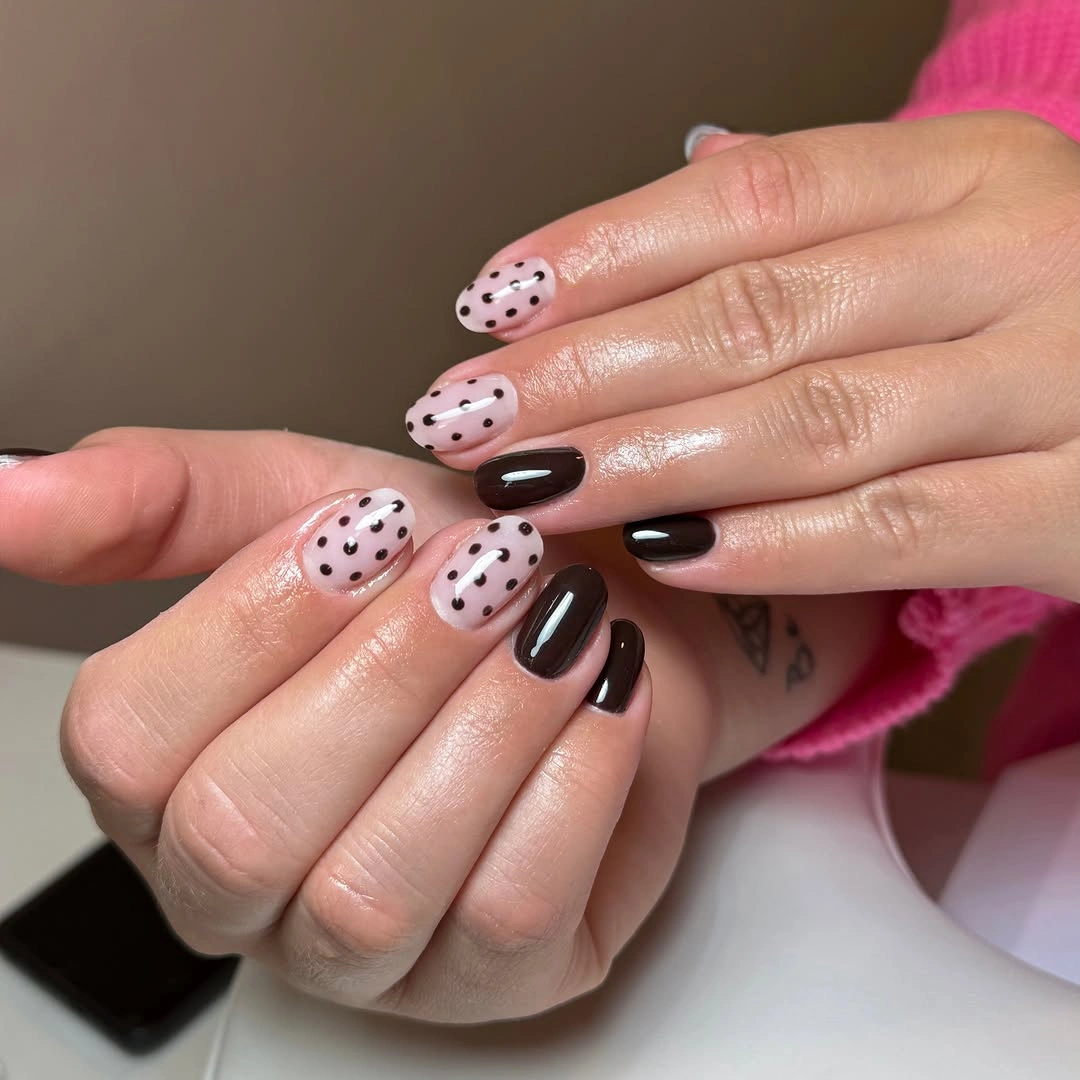 Medium almond nails in soft pink and chocolate with contrasting polka dots