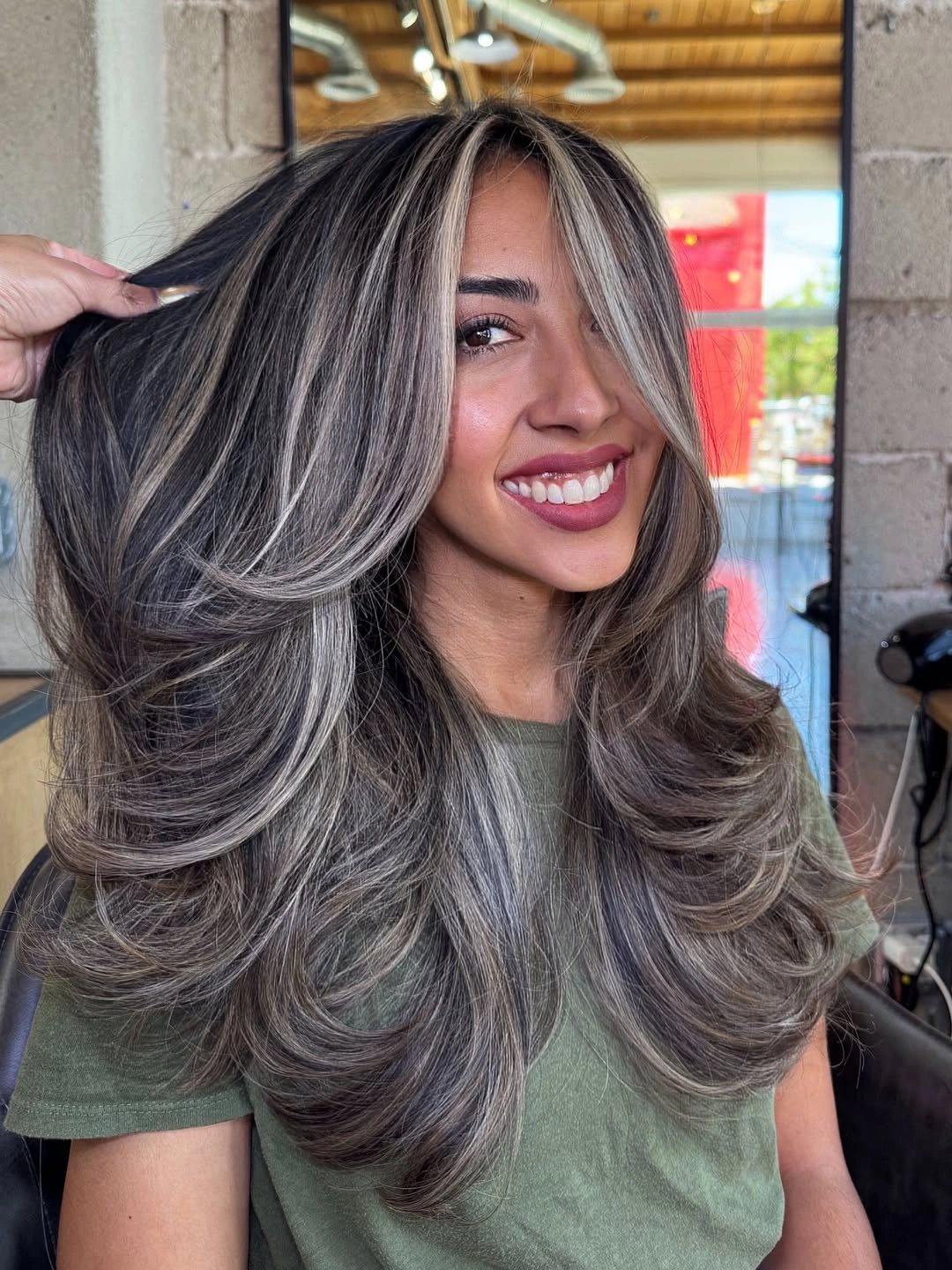 Long silver-gray layered hair with feathered outward ends