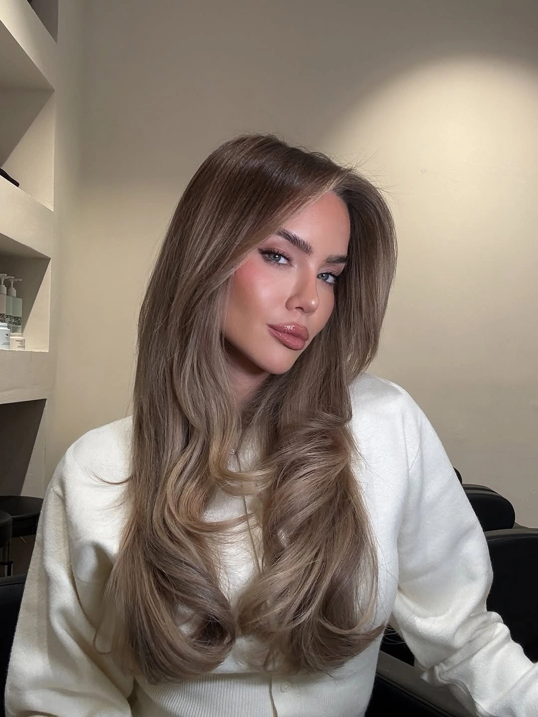 Long cool taupe waves with soft face-framing pieces