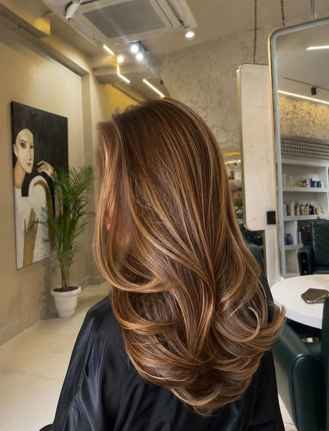 Long warm brown layered waves with caramel ribbons