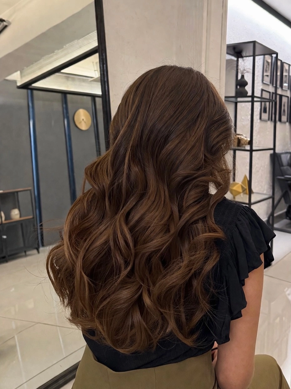 Long deep brunette hair with large continuous waves