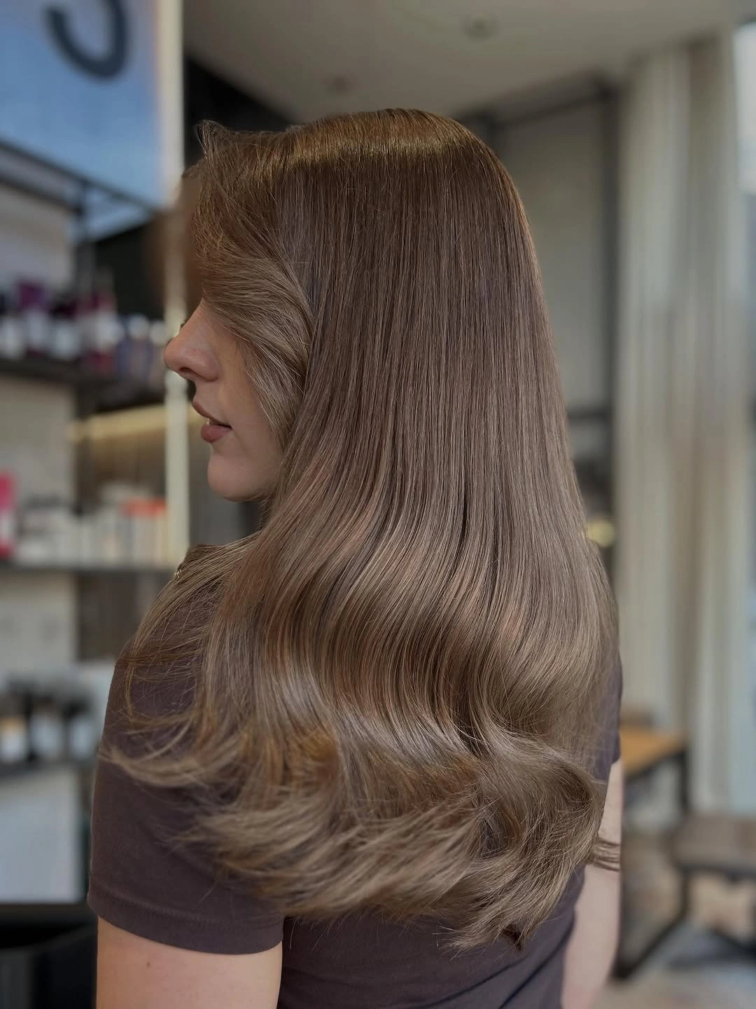Smooth ash-brown long bob with softly flipped ends