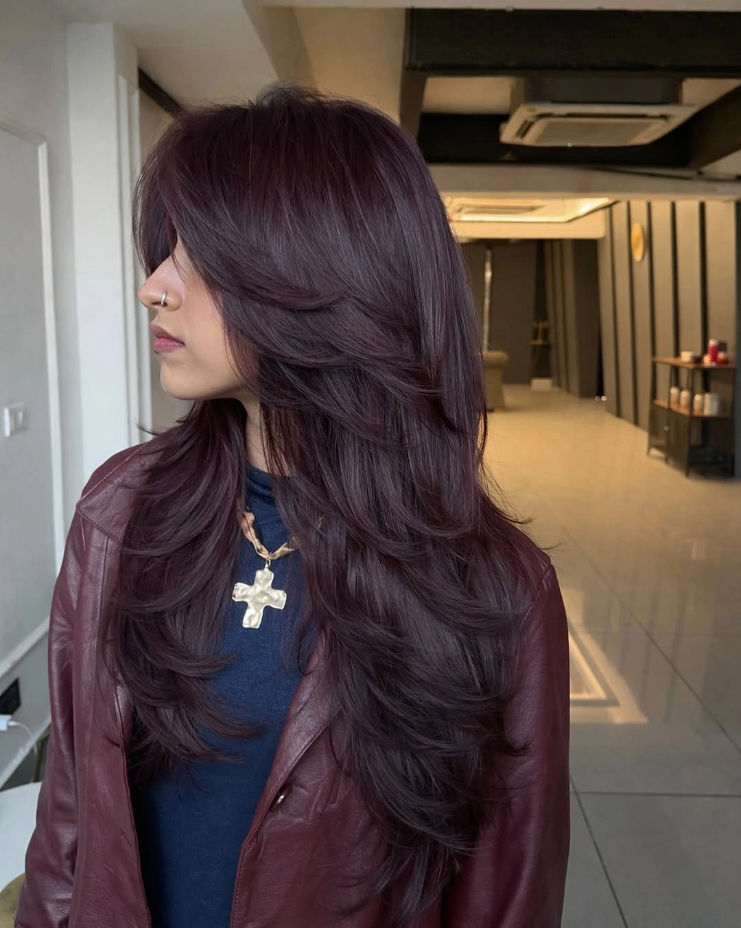 Long plum-brown layered hair with berry-toned movement