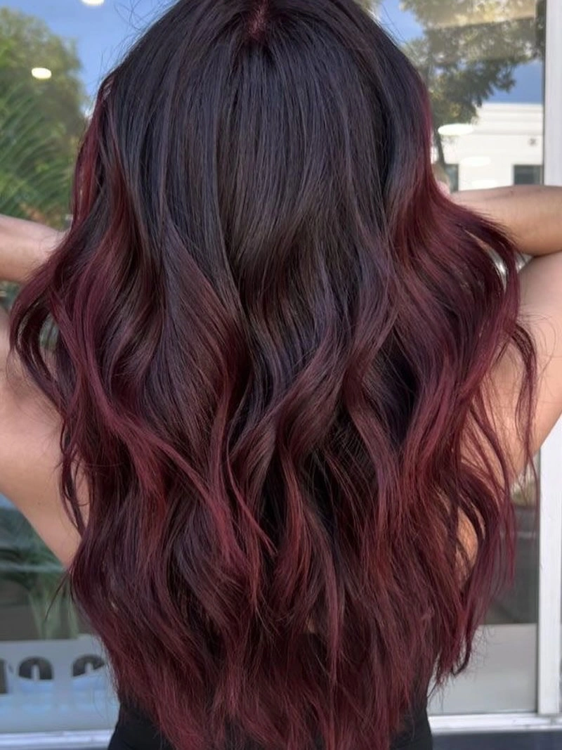 Long dark waves with wine-red ribbons through the lengths