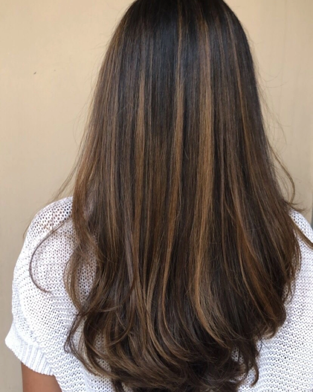 Long straight brunette hair with fine caramel highlight lines