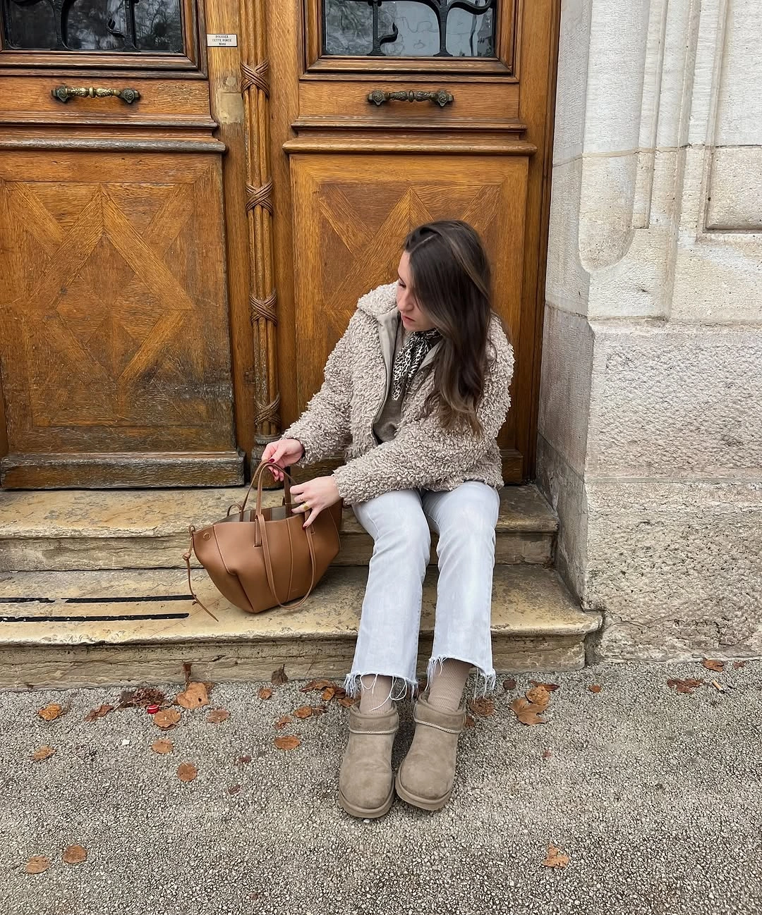 Cream textured cardigan with pale jeans, taupe boots, and brown bag