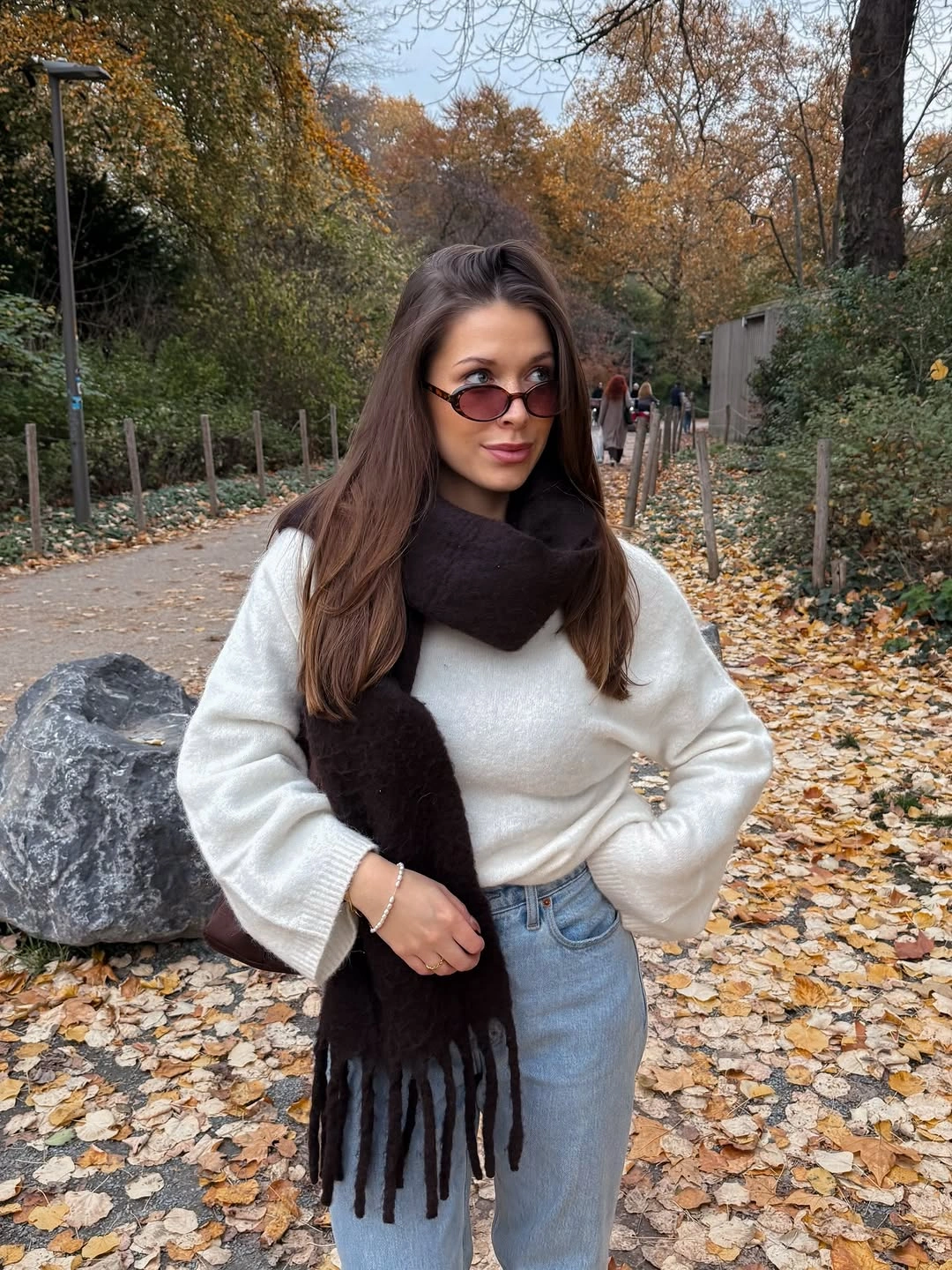 Cream sweater and pale jeans with oversized brown scarf