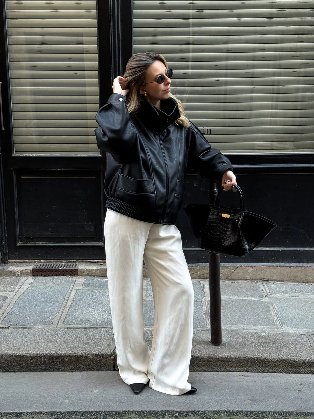 Black jacket with ivory wide trousers and black handbag