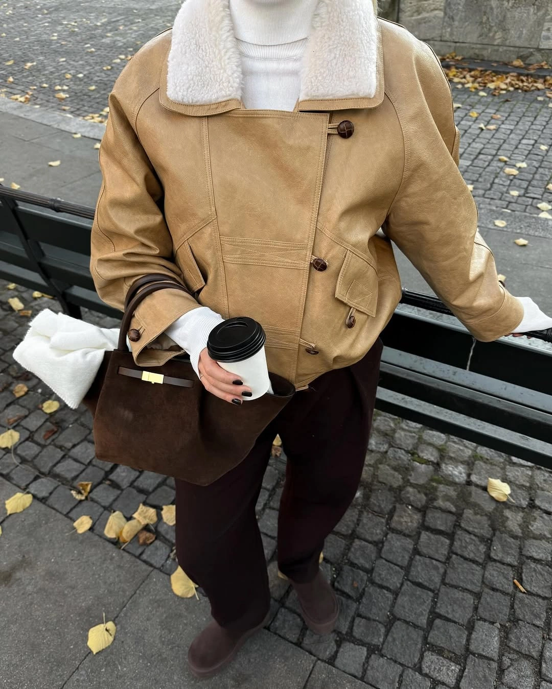 Brown coat and scarf over short dark base with tights