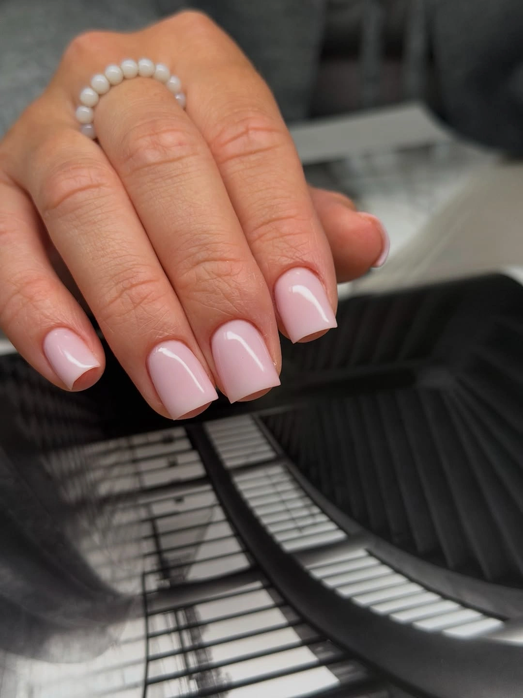 Short glossy blush pink square nails with a clean simple finish