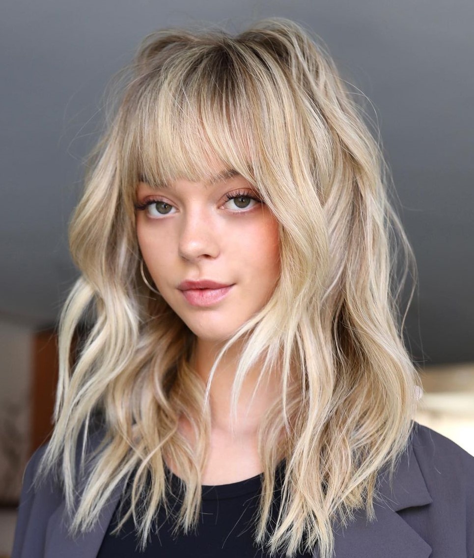 Textured Shag With Full Bangs and Ash Blonde Textured Shag With Full Bangs and Ash Blonde — Winter Hair Colors for Pale Skin