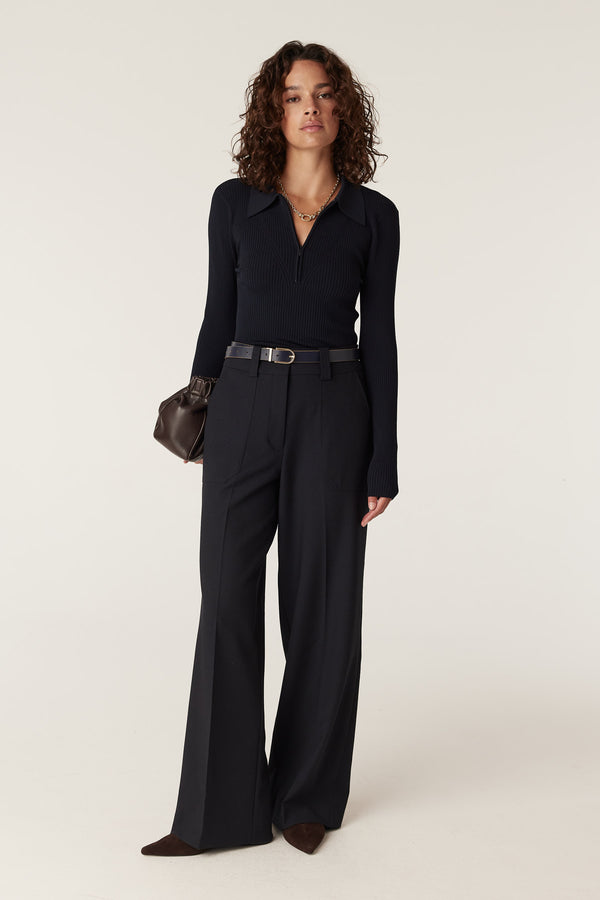 Long Wool Coat Over Cable Knit Sweater and Trousers Long Wool Coat Over Cable Knit Sweater and Trousers — All Black Winter Outfits