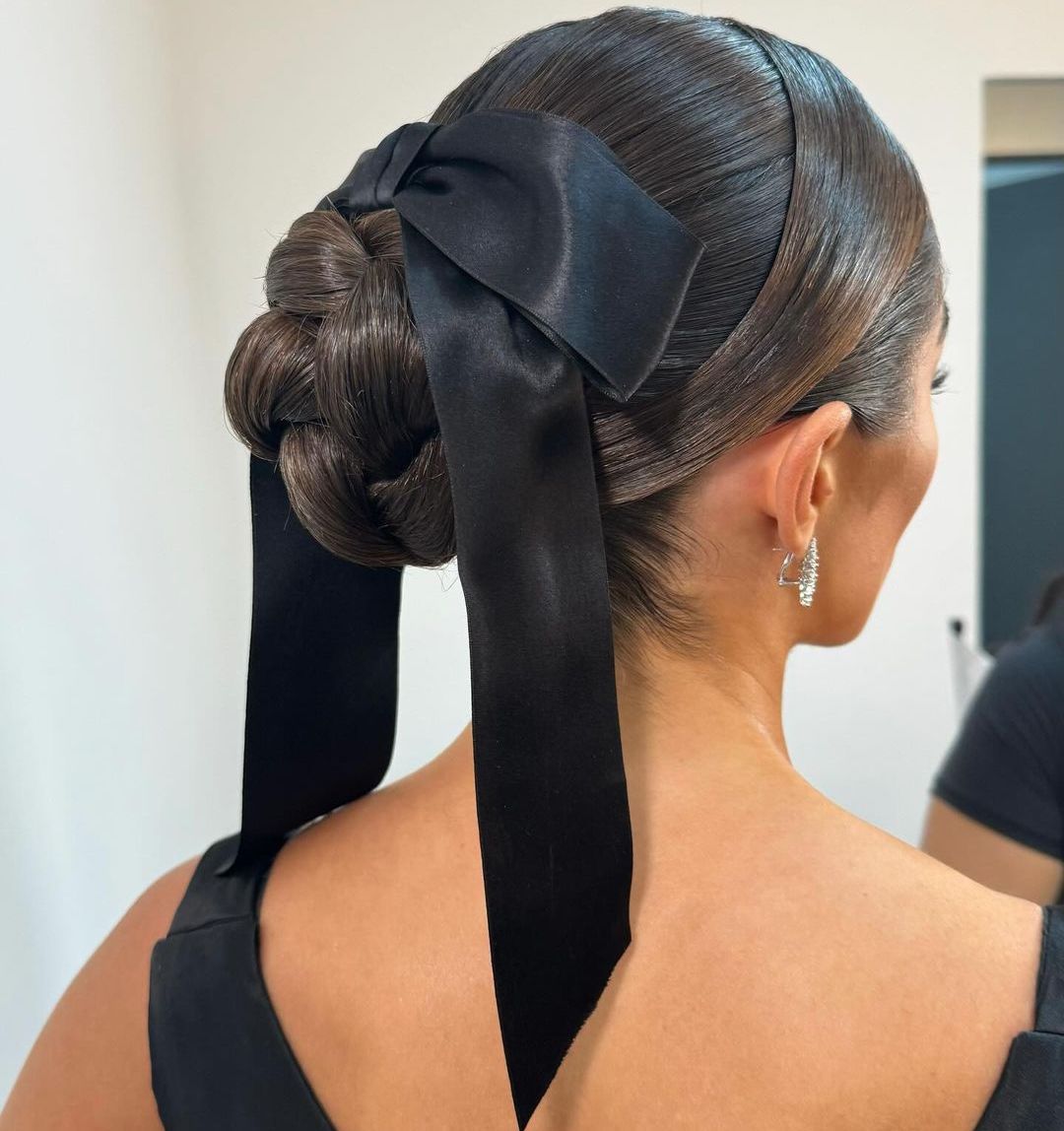 Dark Brown Braided Bun With Black Bow Dark Brown Braided Bun With Black Bow — Winter Party Hairstyles