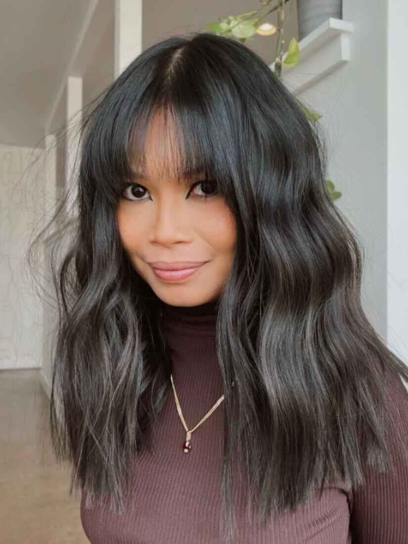 Long Wavy Hair with Blunt Bangs and Grey Streaks Long Wavy Hair with Blunt Bangs and Grey Streaks — Trendy Haircuts for Women